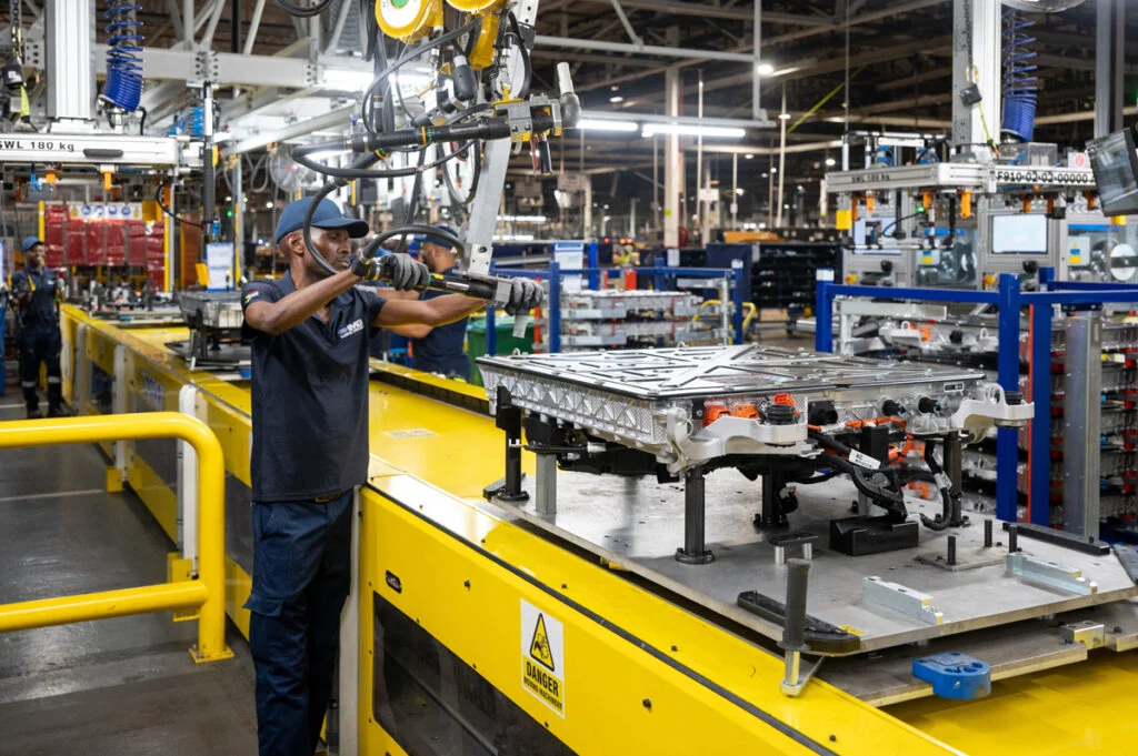 Worker operating heavy machinery on the Volkswagen Kariega plant production line in Gqeberha